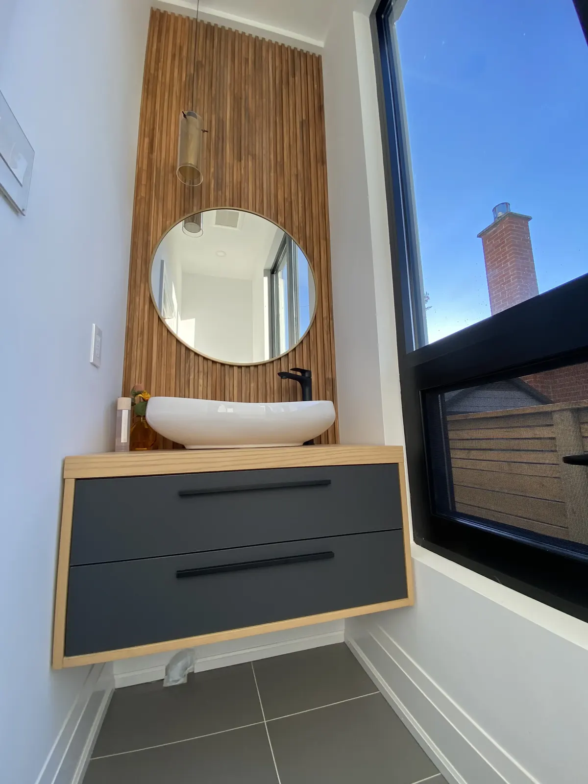 Oak slat feature wall behind a floating vanity
